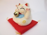 Lucky cat White with bell on red pillow A